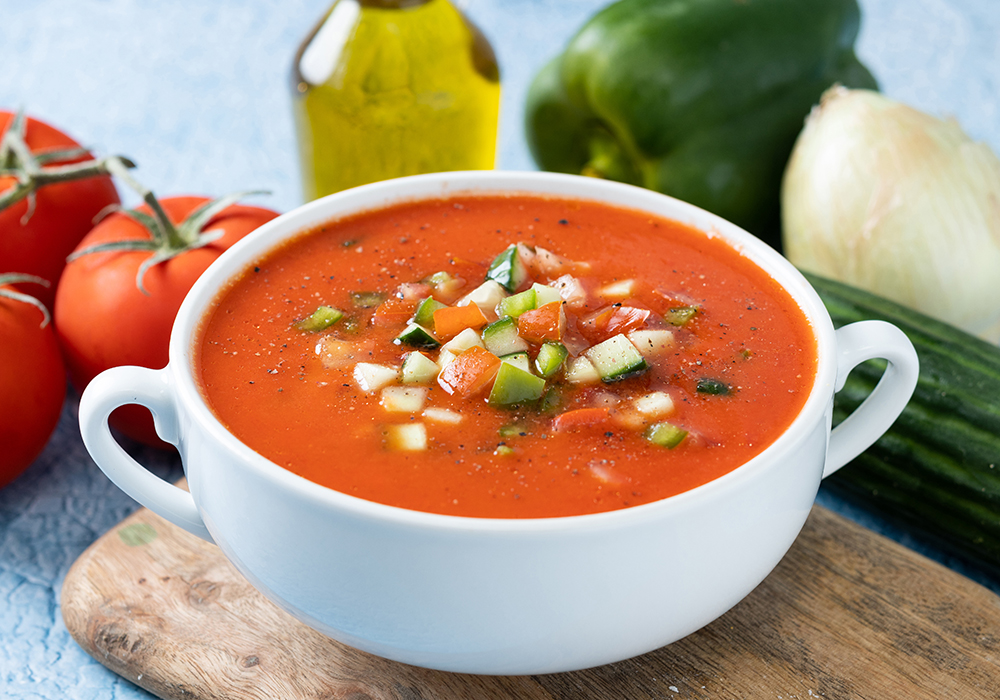 traditional spanish gazpacho soup bowl blue background